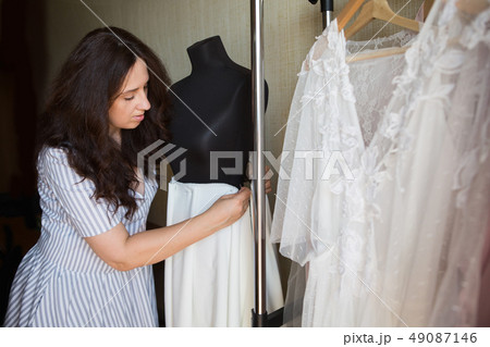 Dress designer making lace wedding dresses. Dress designer making lace wedding dresses. 49087146