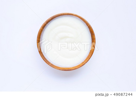 White yogurt in wooden bowl on white White yogurt in wooden bowl on white 49087244