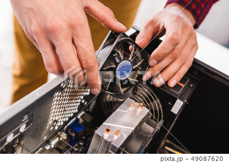 Man examines laptop PC clean dust pollution 49087620