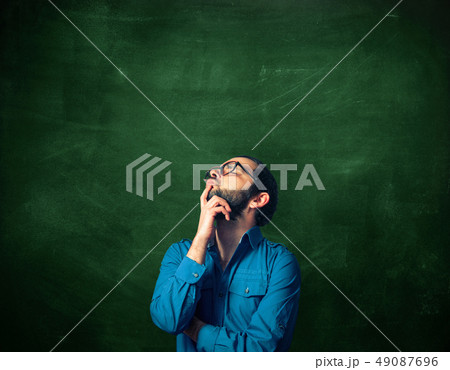 Bearded man on chalkboard background 49087696