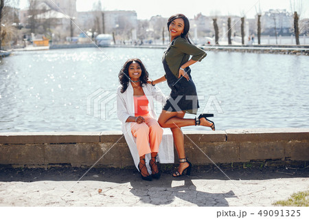 fashionable black girls in a park fashionable black girls in a park 49091325