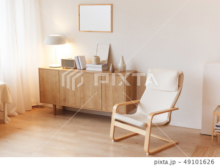 Modern minimalistic interior with chest of drawers an braided armchair. Scandinavian style. Modern minimalistic interior with chest of drawers an braided armchair. Scandinavian style. 49101626