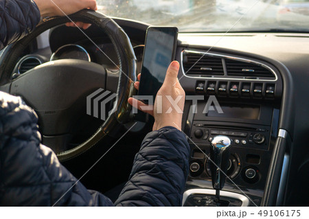 Man driver using smart phone in car Man driver using smart phone in car 49106175