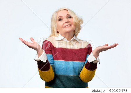 senior woman having a doubting gesture. senior woman having a doubting gesture. 49106473