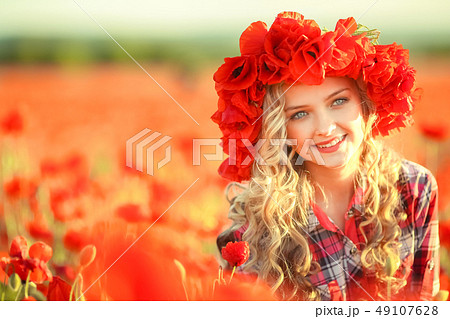 Portrait of a girl on the street with a wreath of poppy flowers on the head Portrait of a girl on the street with a wreath of poppy flowers on the head 49107628