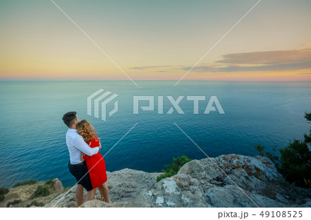 Couple family traveling together on cliff edge in Norway man and woman lifestyle concept summer 49108525