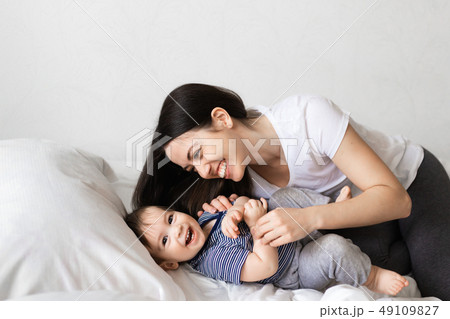 mother and baby boy on bed mother and baby boy on bed 49109827