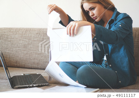 Serious woman focused on finding information on paper. Business and learning 49111117