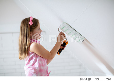 Kids painting attic wall. Home improvement. Kids painting attic wall. Home improvement. 49111798