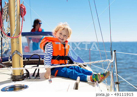 Kids sail on yacht in sea. Child sailing on boat. Kids sail on yacht in sea. Child sailing on boat. 49111915