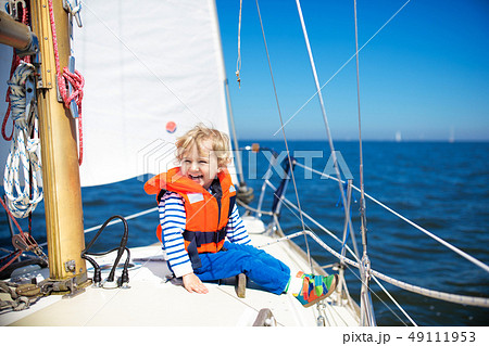 Kids sail on yacht in sea. Child sailing on boat. Kids sail on yacht in sea. Child sailing on boat. 49111953