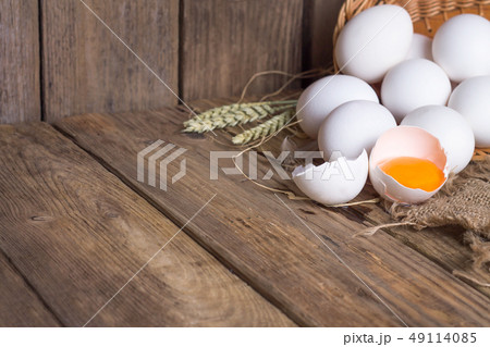 White eggs from the basket and broken egg White eggs from the basket and broken egg 49114085