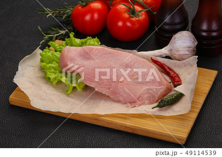 Raw Turkey steak served rosemary Raw Turkey steak served rosemary 49114539