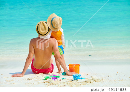 Toddler boy on beach with father 49114683