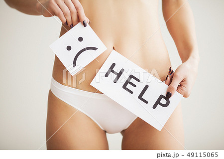 Woman Health Problem. Closeup Of Female With Fit Slim Body In Panties Holding White Card With Sad 49115065