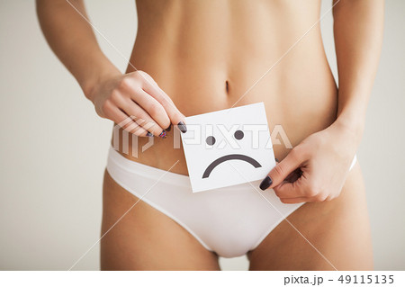 Woman Health Problem. Closeup Of Female With Fit Slim Body In Panties Holding White Card With Sad Woman Health Problem. Closeup Of Female With Fit Slim Body In Panties Holding White Card With Sad 49115135