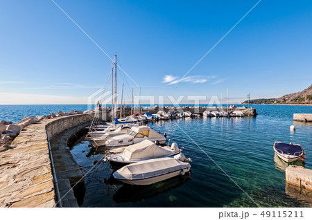 Boats moored in a small harbor in the Gulf of 49115211