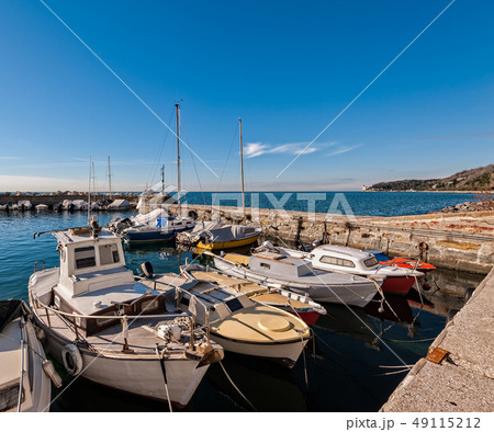 Boats moored in a small harbor in the Gulf of 49115212