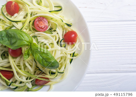 Zucchini pasta noodles with tomatoes . Healthy 49115796
