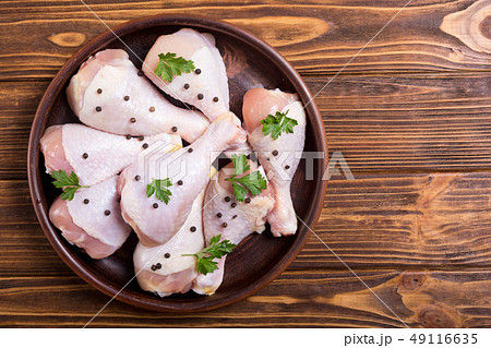 Raw chicken legs with spices and parsley. Food 49116635