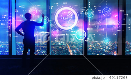 LiFi theme with man by large windows at night LiFi theme with man by large windows at night 49117263