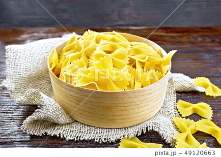 Farfalle in bark box on wooden board Farfalle in bark box on wooden board 49120663
