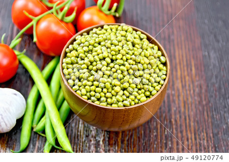 Mung beans in bowl with vegetables on dark board Mung beans in bowl with vegetables on dark board 49120774
