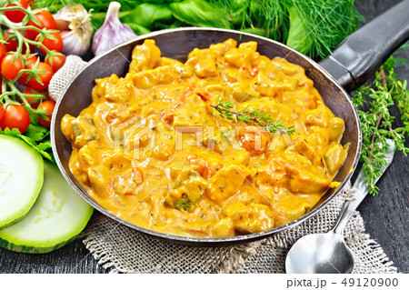 Goulash with tomato and zucchini in pan on burlap 49120900