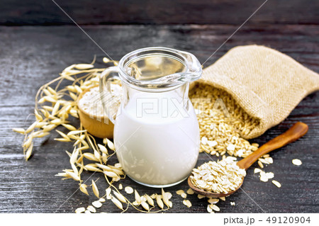 Milk oatmeal in jug on dark board Milk oatmeal in jug on dark board 49120904