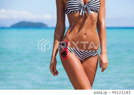 Woman body in bikini and sunglasses 49123183