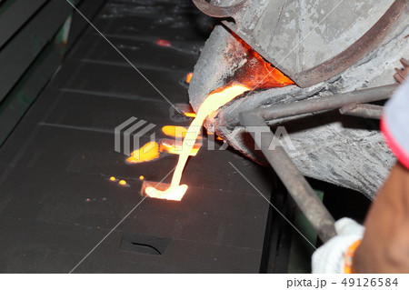 Iron molten metal pouring in sand mold 49126584