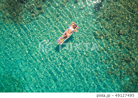 Woman on air mattress in the sea. Young woman on 49127495