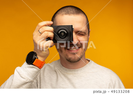 Man put camera to his eye. Photographer or videographer Man put camera to his eye. Photographer or videographer 49133208