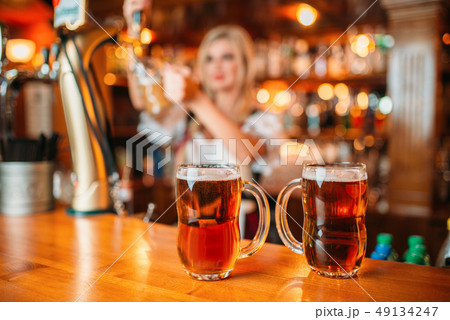 Two glasses of fresh beer on counter, octoberfest 49134247