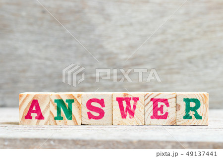 Letter block in word answer on wood background Letter block in word answer on wood background 49137441