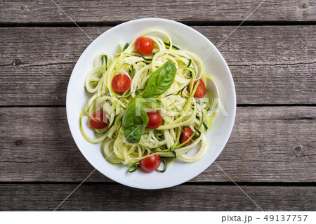 Zucchini pasta noodles with tomatoes . Healthy 49137757