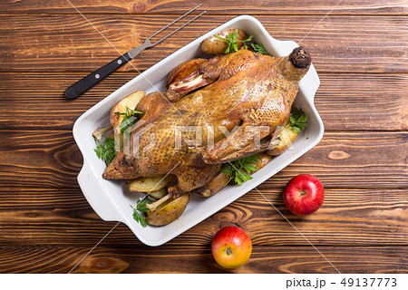 Homemade baked duck with potatoes and apple . 49137773
