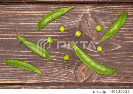 Green sugar snap pea on brown wood Green sugar snap pea on brown wood 49139288
