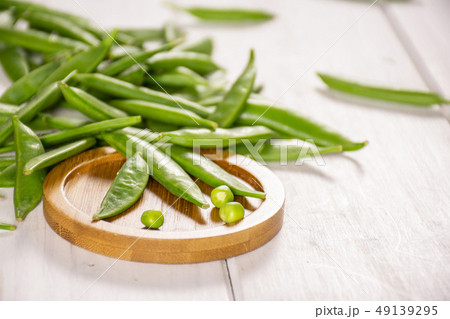 Green sugar snap pea on grey wood Green sugar snap pea on grey wood 49139295