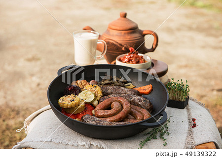 Grilled sausages with vegetables Grilled sausages with vegetables 49139322