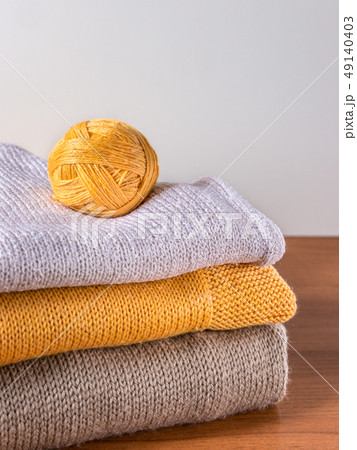 yarn and knitwear on wooden table yarn and knitwear on wooden table 49140403
