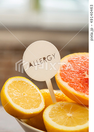 Selective focus of halves of lemons and grapefruits in white bowl Selective focus of halves of lemons and grapefruits in white bowl 49140463