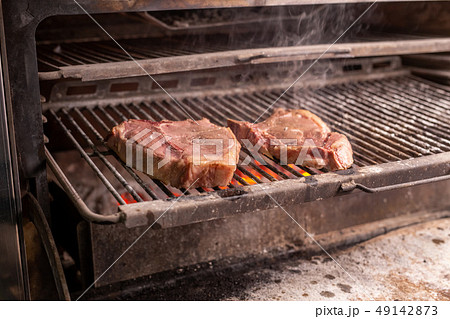 food, craft and delicious concept - cooking steak on a grill food, craft and delicious concept - cooking steak on a grill 49142873