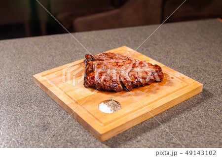 food, delicious and craft concept - cutting horse meat steak on wooden desk 49143102