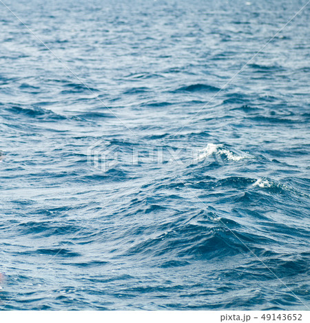 Wide shot of a beautiful clear turquoise sea ocean water surface with low ripples and subtle waves Wide shot of a beautiful clear turquoise sea ocean water surface with low ripples and subtle waves 49143652
