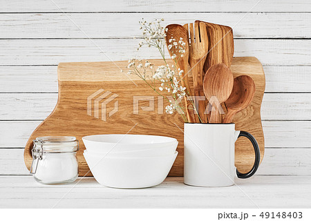 Kitchen tools and cutting board on white table 49148403