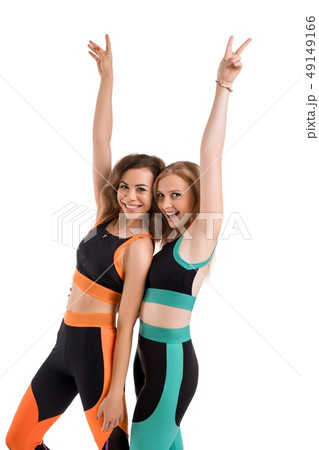 Two slim girls in sportswear doing fitness view Two slim girls in sportswear doing fitness view 49149166