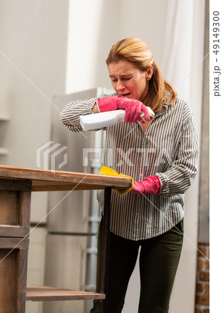 Blond-haired housewife feeling tired of allergy and sneezing 49149300