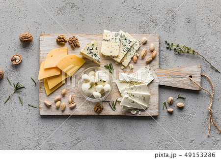 Assortment of cheese with nuts on wooden board Assortment of cheese with nuts on wooden board 49153286