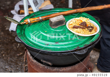 Cooking traditional Uzbek pilaf in a large Cooking traditional Uzbek pilaf in a large 49155519